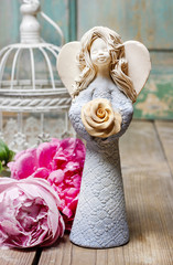 Ceramic angel on wooden table