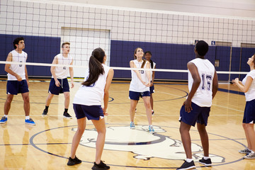 High School Volleyball Match In Gymnasium