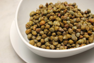 Marinated capers on a white plate