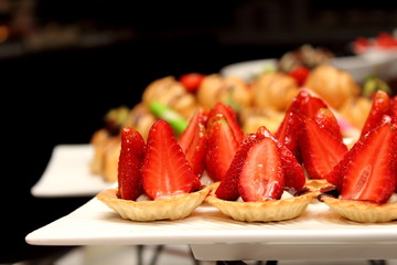 tasty mini tarts with strawberry and vanilla cream