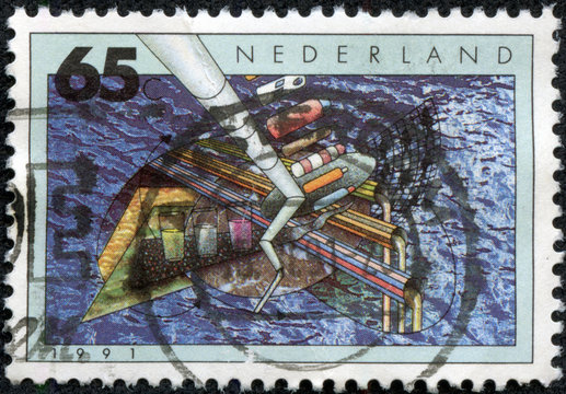 stamp printed in Netherlands shows ship and crane in sea port