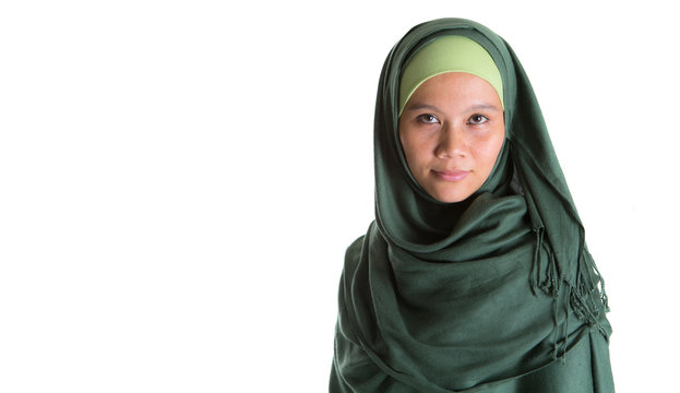 Muslim woman in green hijab over white background