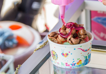 jam pouring into a bowl of nutritious and delicious coco flake c
