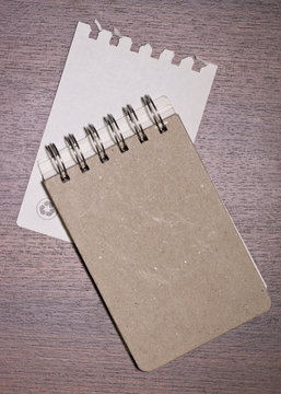 brown blank note book on wood