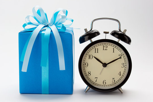 Blue gift box and retro alarm clock