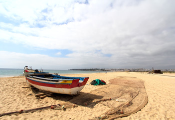 Ship mans boat with fishing net on the beach, Lagos, Portugal