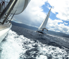 Sailing yacht on the race in a stormy sea.