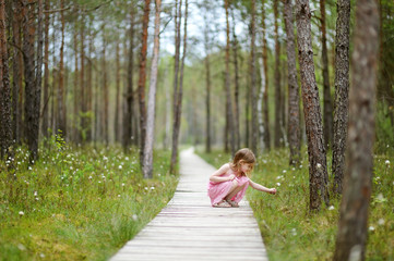 Cute little girl walking in the woods