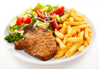 Pork chop, French fries and vegetables