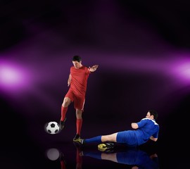 Naklejka premium Football players tackling for the ball