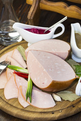 sausages on a wooden plate with vegetables in a restaurant