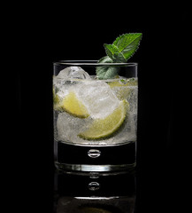 mojito with mint and ice on a black background