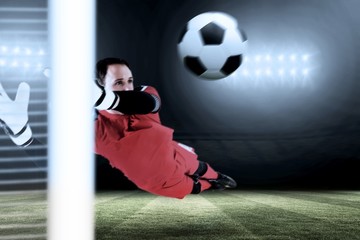 Composite image of fit goal keeper jumping up