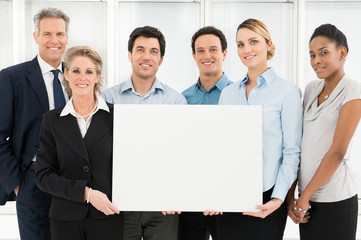 Smiling Teamwork Holding Blank Sign