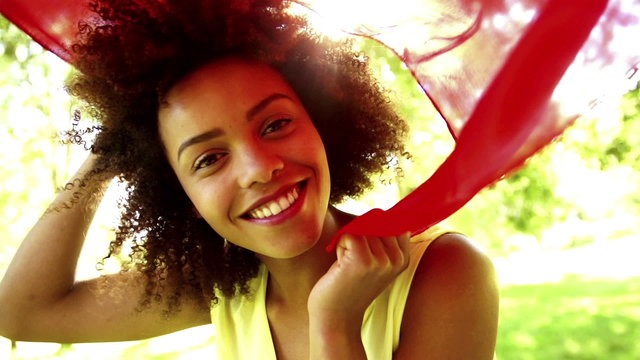 African American Woman waving red scarf