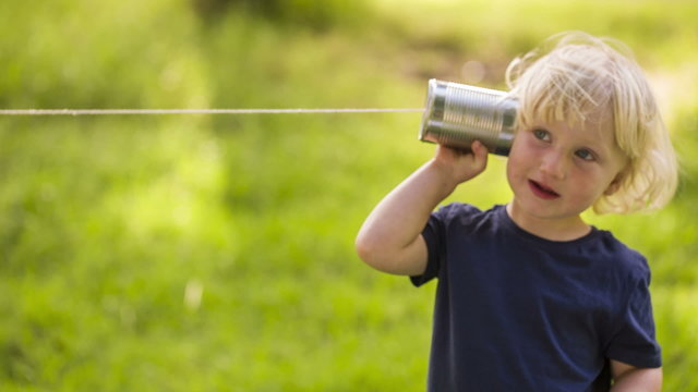 Boy using a string can phone
