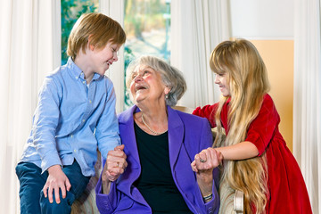 Grandchildren visiting their elderly grandmother.