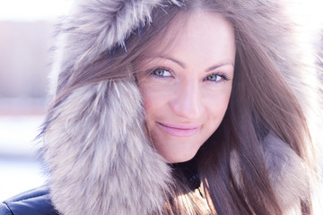 Beautiful girl in winter standing in the hood