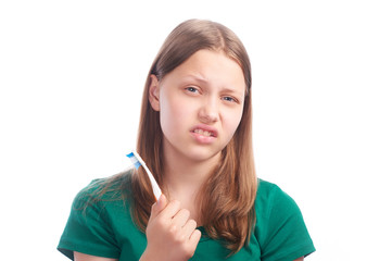 Sad teen girl with toothbrush