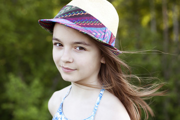 Little girl wearing a hat outdoors