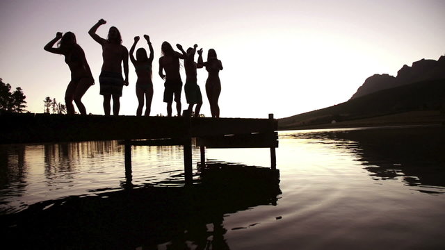 Lake party on lake jetty in sunset