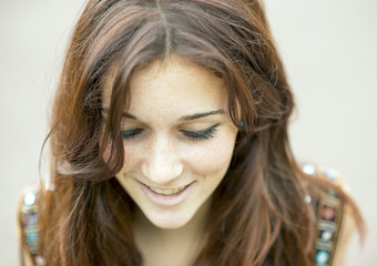 Closeup portrait of smiling beautiful woman looking down.