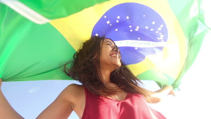 Cheerful girl from brazil with brazilian flag in slow motion - Powered by Adobe