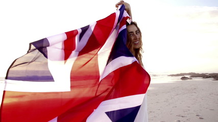 English Woman running with Union Jack on beach - Powered by Adobe