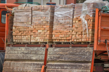 clay building bricks delivered to the job site in pallets