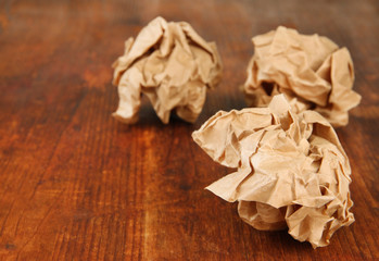 Crumpled paper balls on wooden background