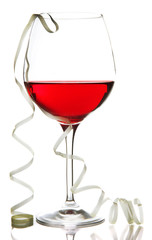 Glass of red wine and streamer after party isolated on white