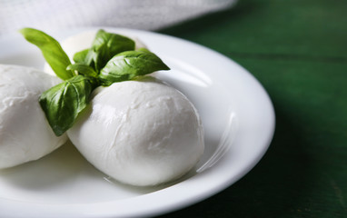 Tasty mozzarella cheese with basil