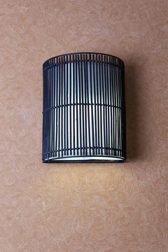 Modern lamp on wall in room
