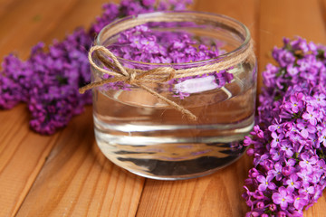 Obraz na płótnie Canvas Beautiful lilac flowers on table close-up
