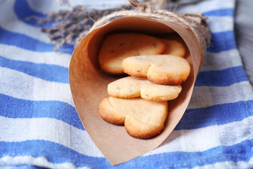 Lavender cookies in paper bag, on color napkin background