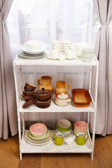 Different tableware on shelf in the interior