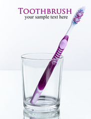 Toothbrush in glass isolated on white