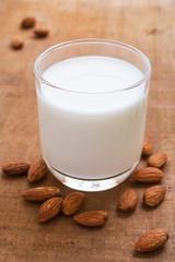 Almond milk and almond on wooden table