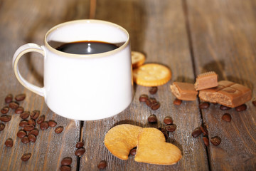 Cup with hot coffee  and sweet cookies,