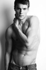 Handsome muscular guy with naked torso, bw photo