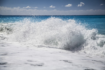 Blue sea with waves and sky with clouds