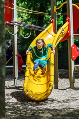 Preschooler girl sliding on a teeter board