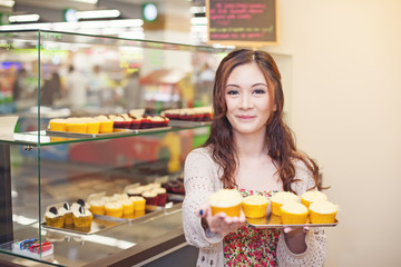 Pretty asian woman working at her own store