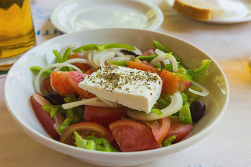 fresh tasty greek salad served on a plate