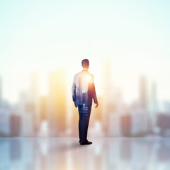 double exposure of businessman and city