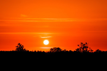 Fototapeta na wymiar Countryside sunset in dark red color