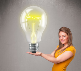 Beautiful lady holding realistic 3d light bulb