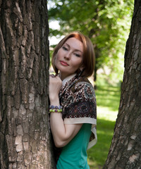 beautiful woman at a tree in summer