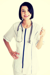 Female doctor or nurse holding digital thermometer