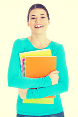 Beautiful young woman student with workbook.